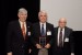 Prof. Grandon Gill, Chair of the Award Ceremony, and Dr. Nagib Callaos, General Chair, Gill giving Prof. Tomás Zelinka a plaque "In Appreciation for Delivering a Great Keynote Address at a Plenary Session."